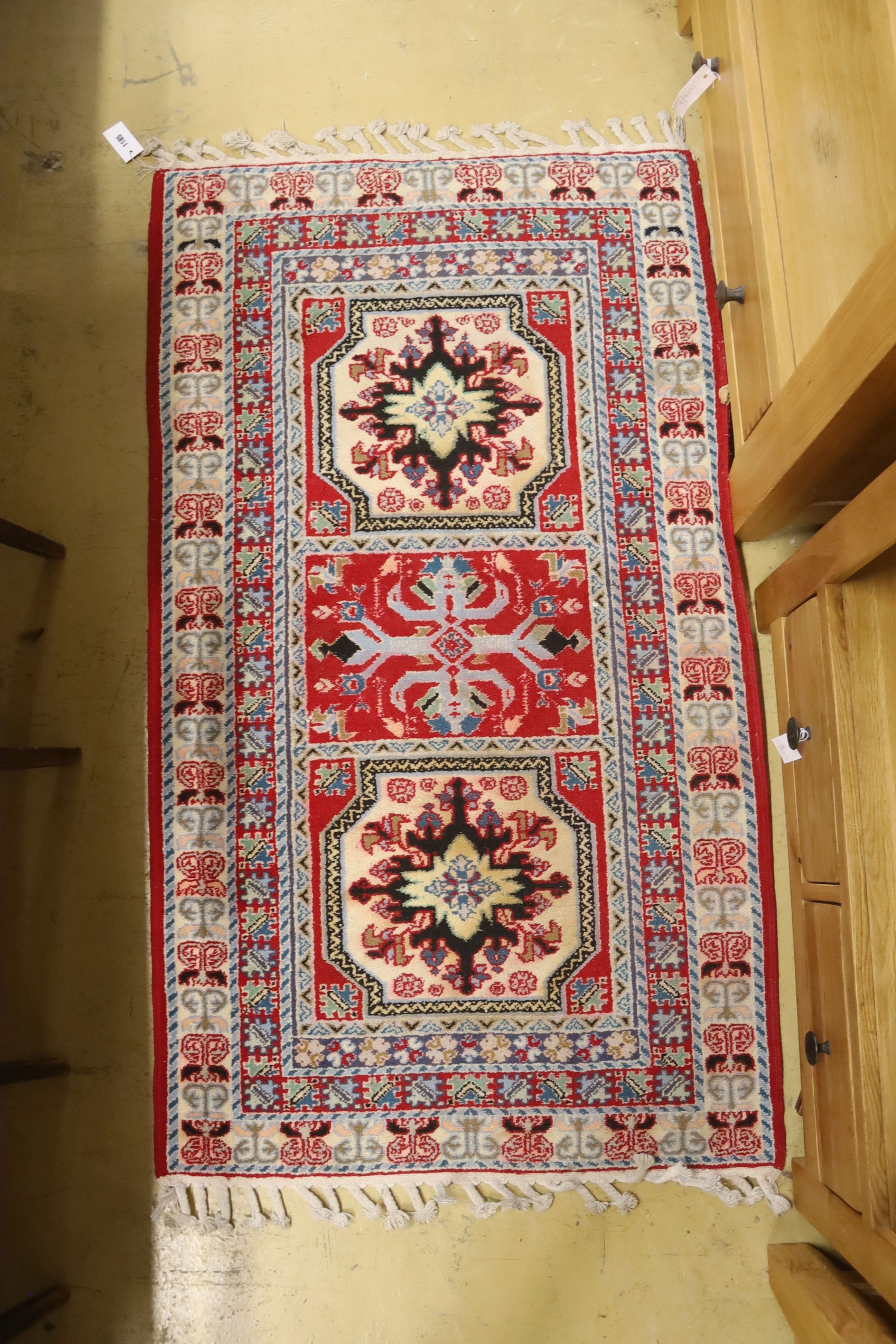 A Kazak style ivory ground rug, 144 x 64cm